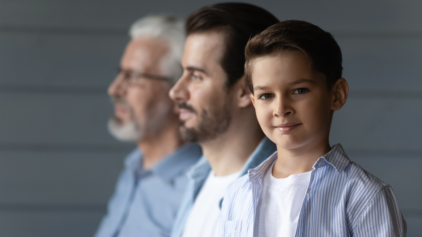 Portrait of small boy with father and grandfather